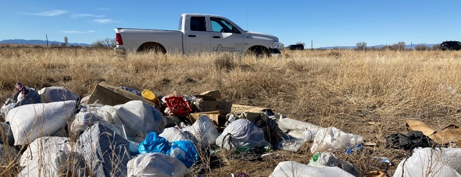 PDPHE truck waiting to haul trash from an illegal dumping site.