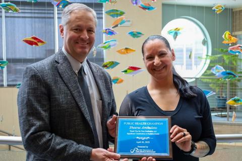2023 Public health Champion receiving plaque from Public Health Director Randy Evetts